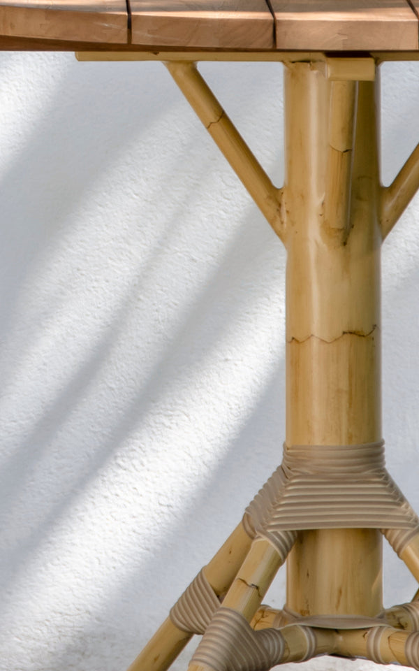 Esta es una imagen de detalle de Nicole Cáfe Table | Teak Ø80 cm en natural aluminium artfibre. Detalle de la textura tejida y construcción de la estructura.