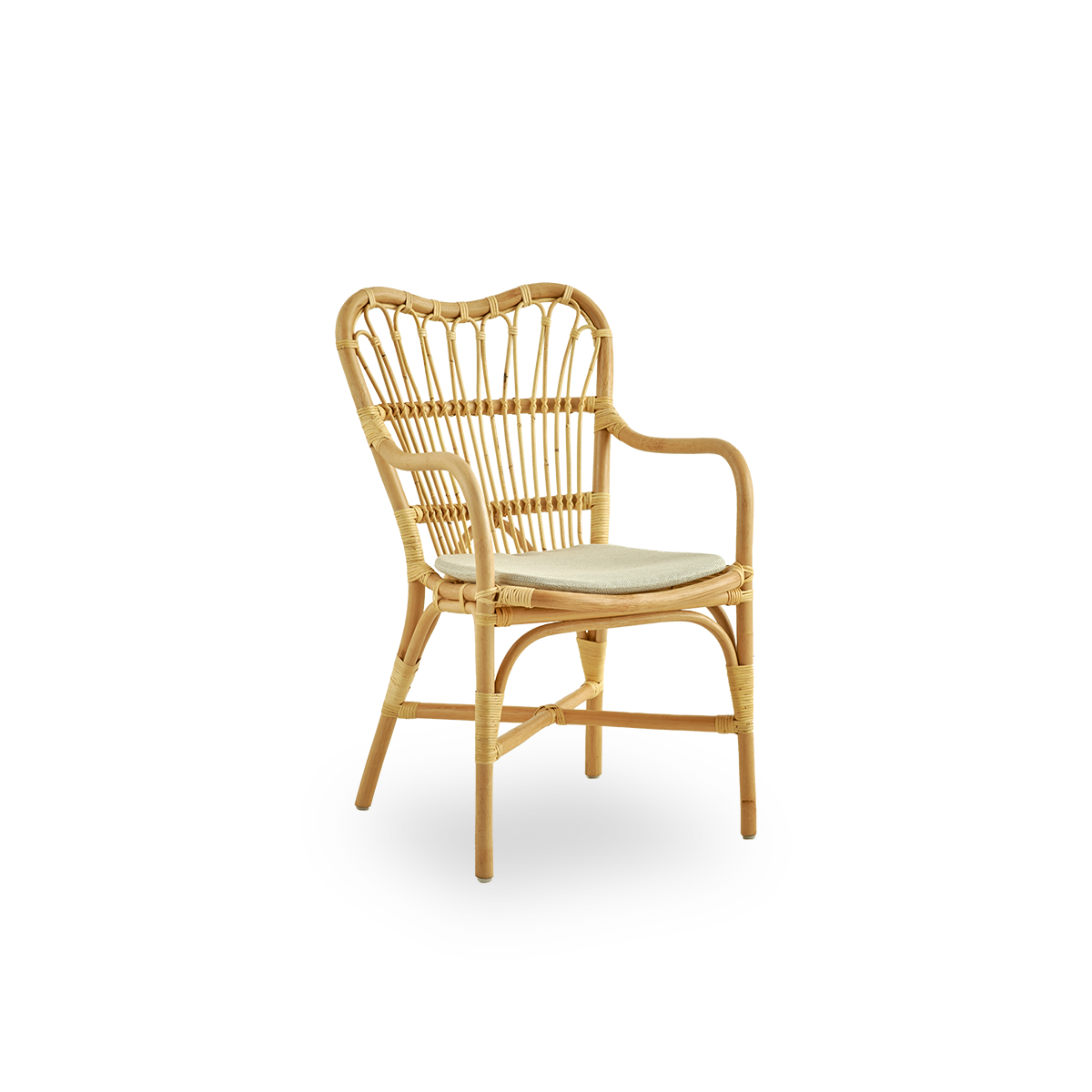 Side view of Margret dining chair with high wide backrest and curved armrests. Handcrafted from high-quality Indonesian rattan.