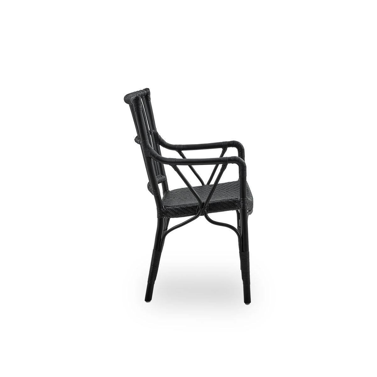 Plain side view of Piano armchair in black color. Elegant wicker chair with high backrest and armrests handcrafted from high quality Indonesian rattan.