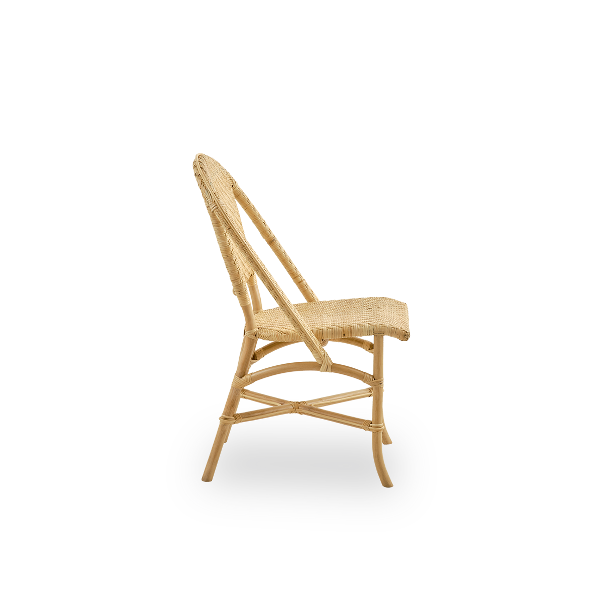 Vista lateral simple de la silla de comedor Alanis en ratán natural de alta calidad, con curvas elegantes y tejido detallado.