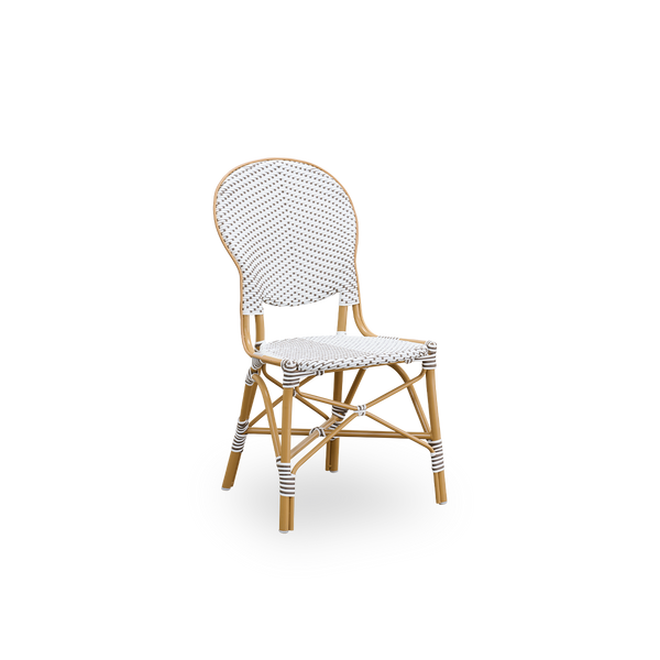 Vista lateral de la silla de comedor de exterior Isabell. Estructura de aluminio color almendra con asiento y respaldo de ArtFibre blanco con puntos marrones. Inspirada en el diseño de bistró de los años 50.