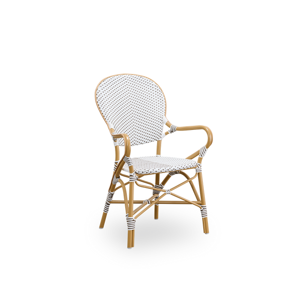 Vista lateral de la silla de comedor de exterior Isabell. Estructura de aluminio color almendra con asiento y respaldo de ArtFibre blanco con puntos marrones. Inspirada en el diseño de bistró de los años 50.
