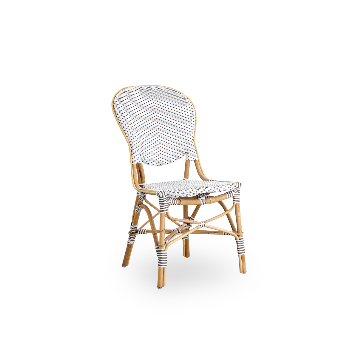 Vista lateral de la silla de comedor Isabell. Estructura de ratán con asiento y respaldo en ArtFibre blanco con puntos marrones. Inspirada en el diseño de bistró de los años 50.