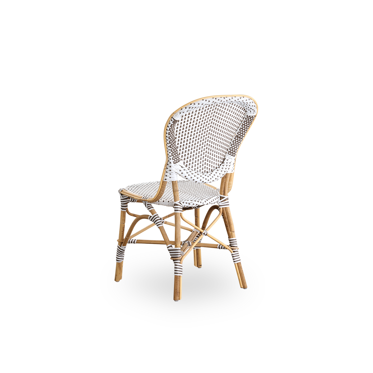 Vista trasera de la silla de comedor Isabell.
Estructura de ratán con asiento y respaldo de ArtFibre blanco con puntos marrones. Inspirada en el diseño de bistró de los años 50.