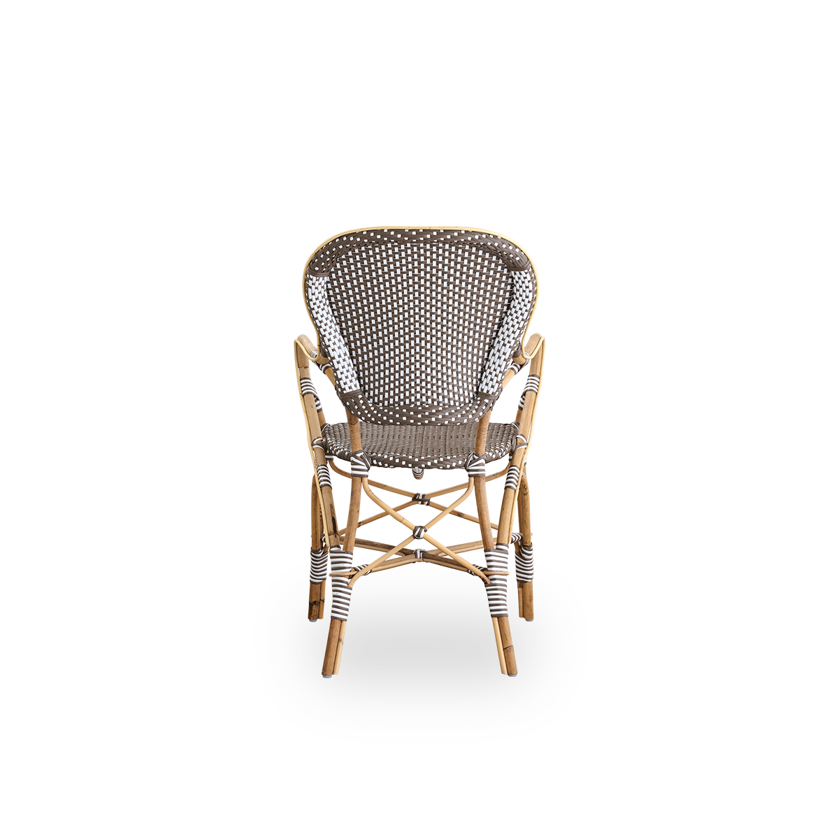 Vista desde atrás de la silla de comedor Isabell con reposabrazos. Estructura de ratán con asiento y respaldo de ArtFibre marrón con puntos blancos. Inspirada en el diseño de bistró de los años 50.