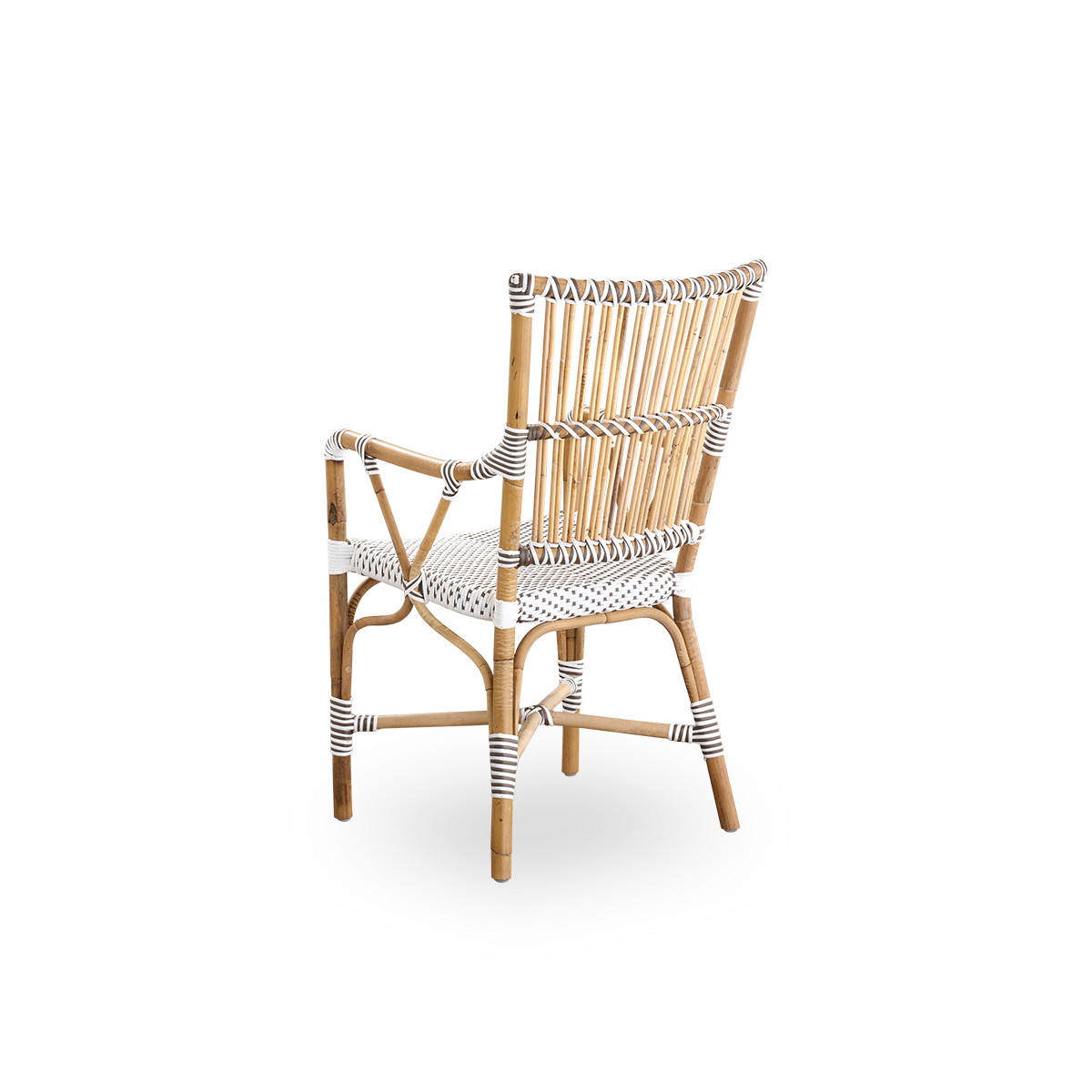 Vista trasera de la silla de comedor Monique con reposabrazos.
Estructura de ratán con asiento tejido en ArtFibre blanco con puntos marrones. Inspirada en el diseño de bistró de los años 50.