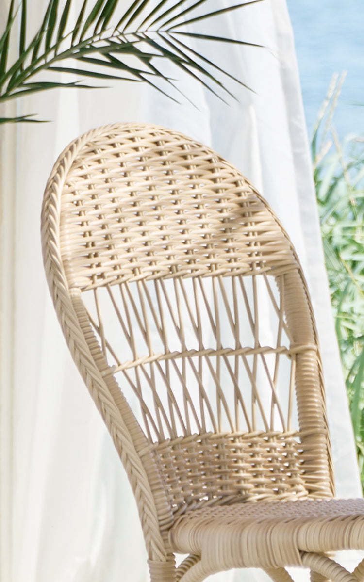 Esta es una imagen de detalle de Ofelia Exterior Chair i natural artfibre aluminium. Detalle del respaldo redondeado tejido y el tejido del asiento.