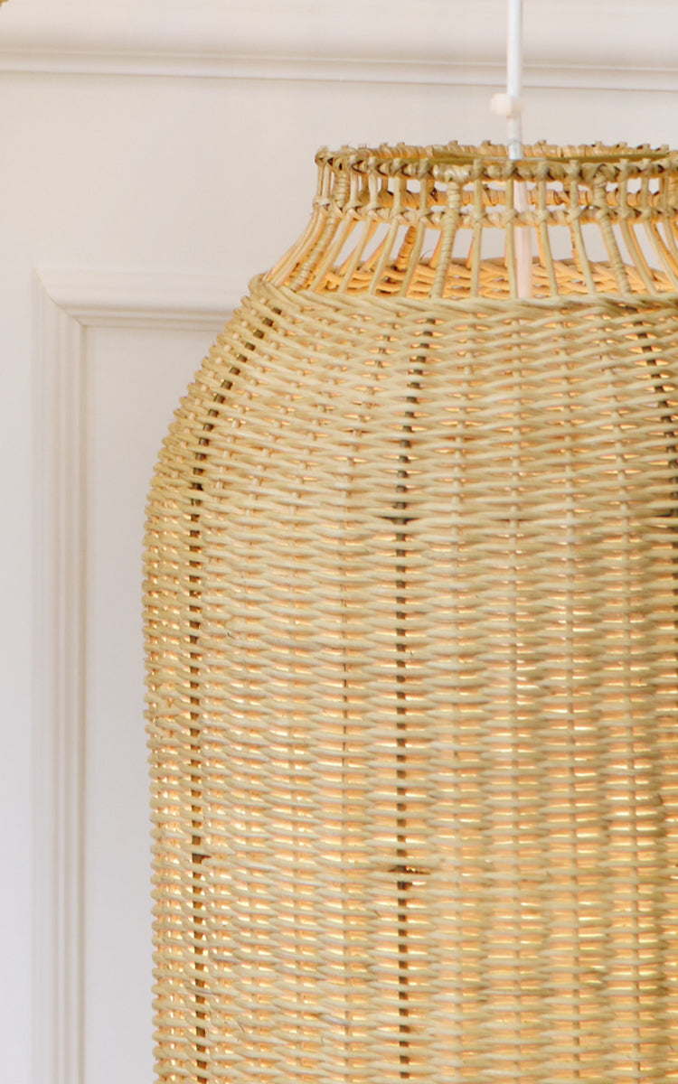 Esta es una imagen de detalle de Kou pantalla de lámpara en natural core weave rattan frame. La forma de linterna tejida y el cálido resplandor se destacan.