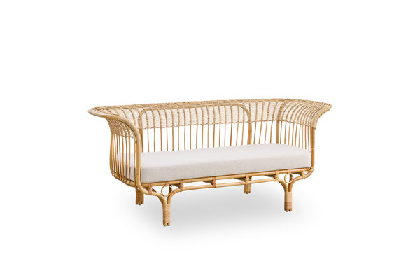 Vista lateral del sofá Belladonna en ratán natural, diseñado por Franco Albini y Franca Helg. El sofá tiene una expresión elegante con patas delgadas y un asiento majestuoso con numerosos detalles de tejido.