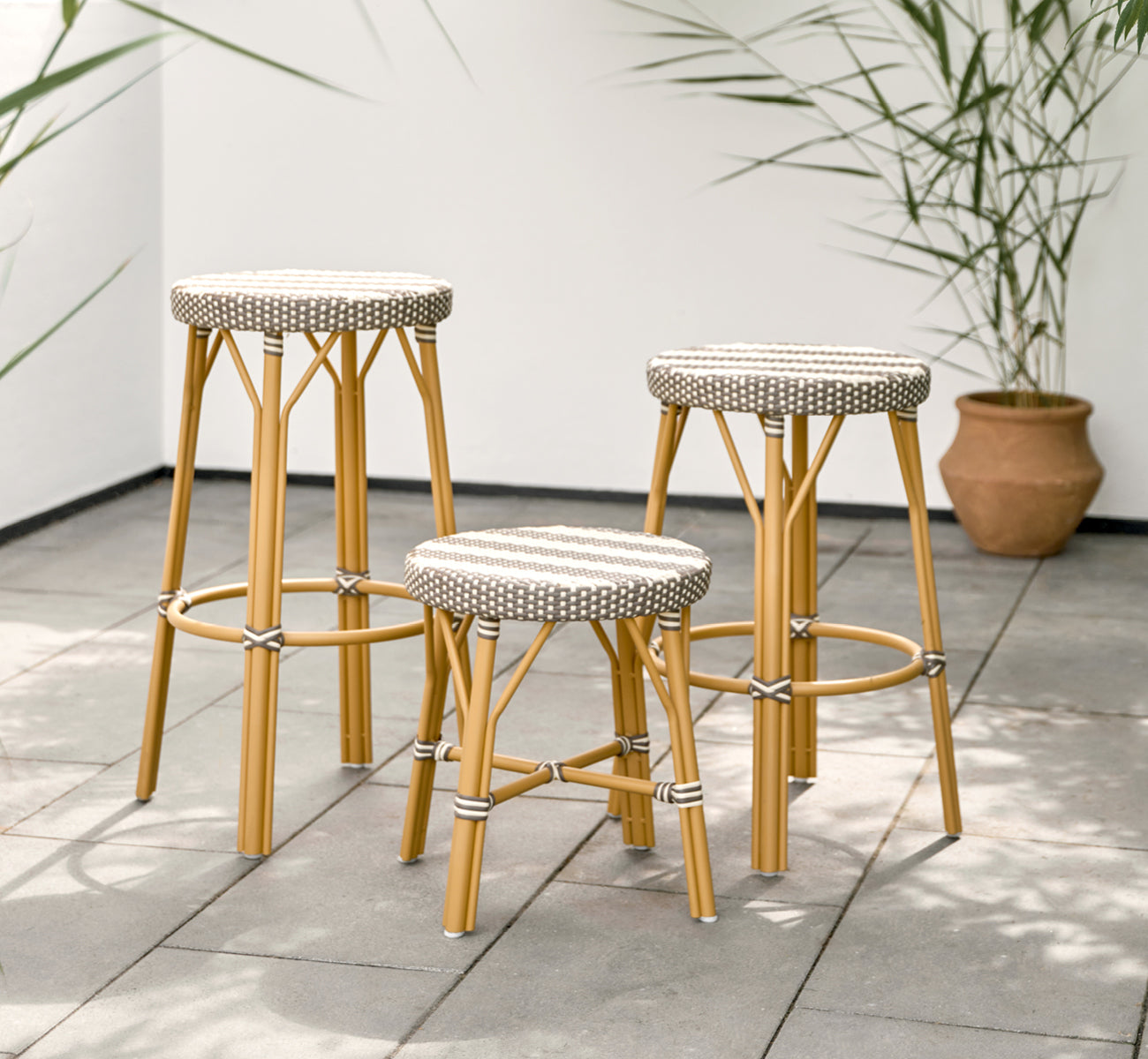 Esta es una imagen de estilo de vida de Simone taburete de bar exterior en almond aluminium frame striped cappuccino ivory artfibre.